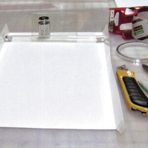 image showing a workspace for coating photographic paper including the paper and various tools